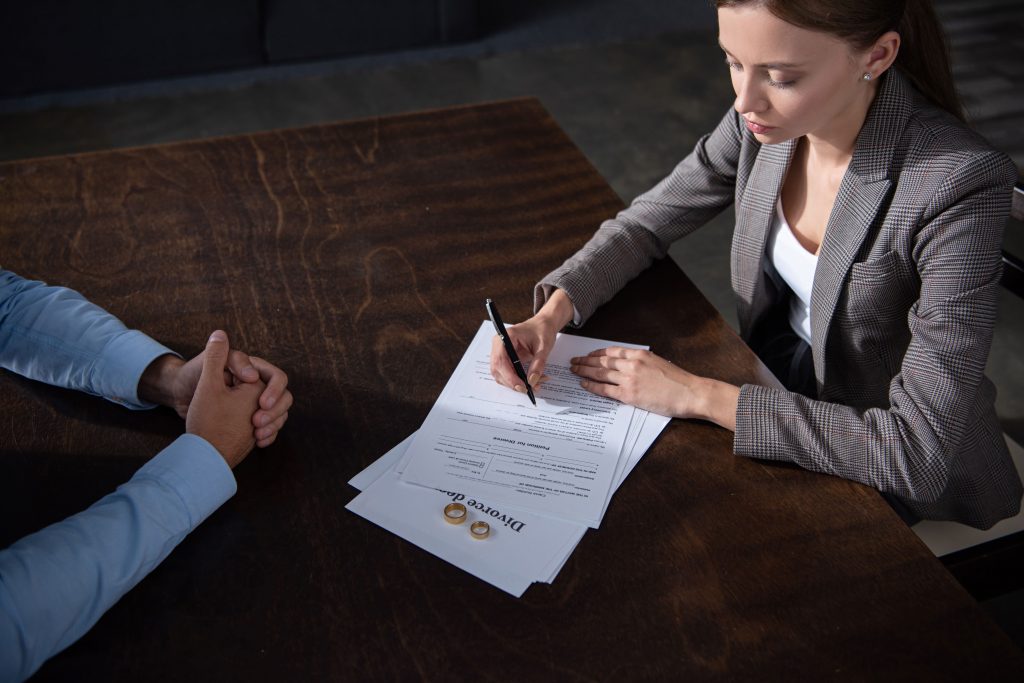 divorce mediation where man is going through documents with divorce mediation lawyers