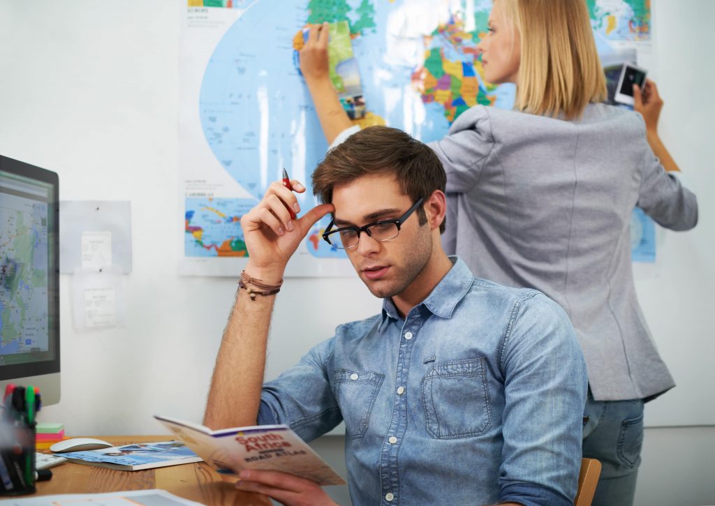 couple trying to decide where to go on holiday and suffering from relationship stress
